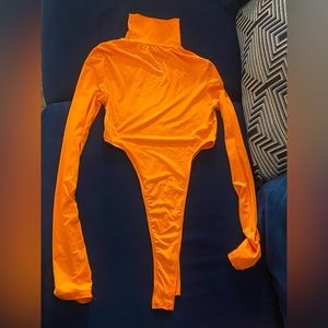 Orange turtleneck body suit